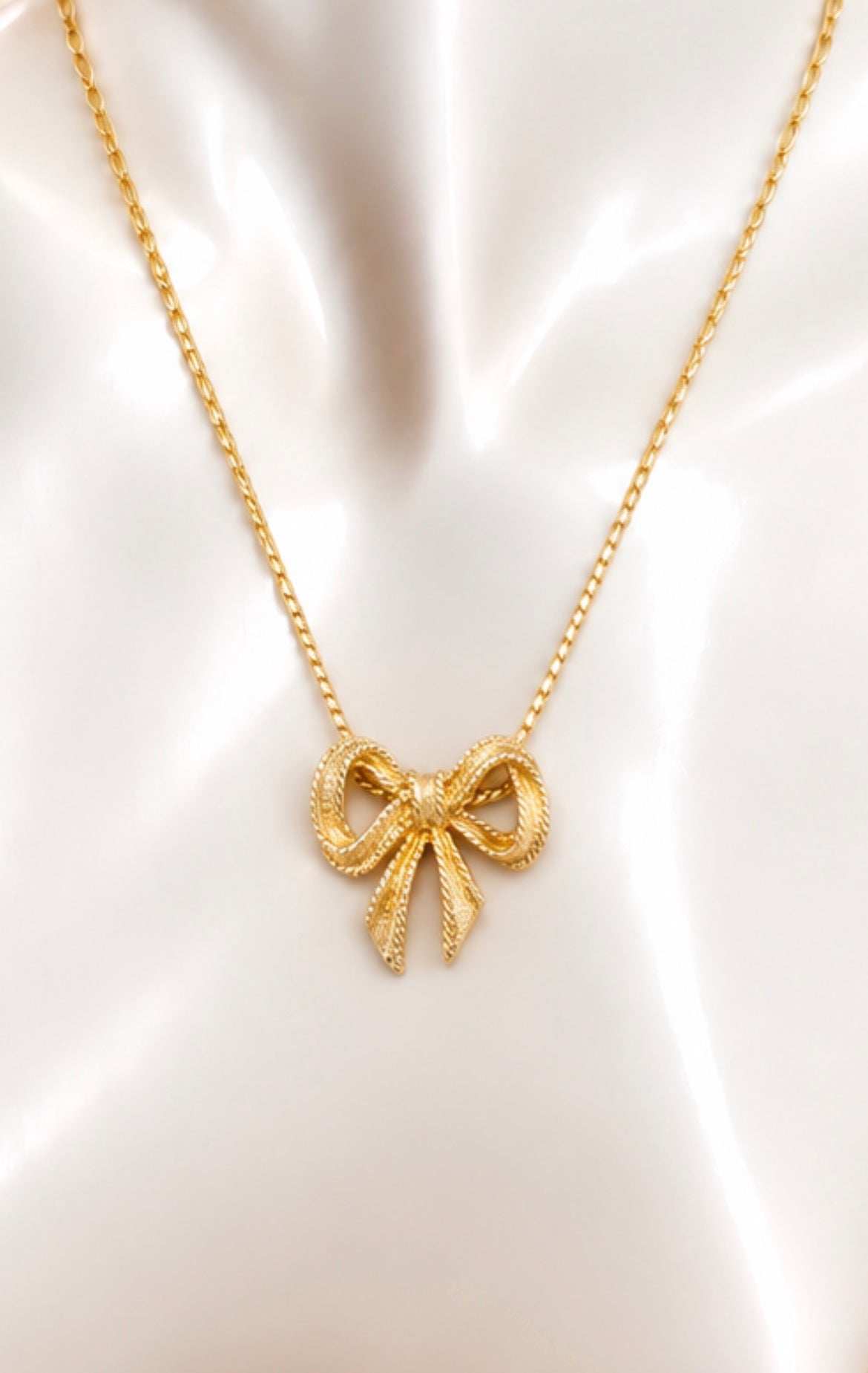 Vintage Avon Gold-Tone Textured Bow Pendant Necklace, view 2